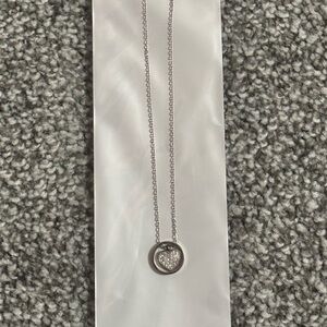 Silver necklace with heart shaped charm with diamond embellishments